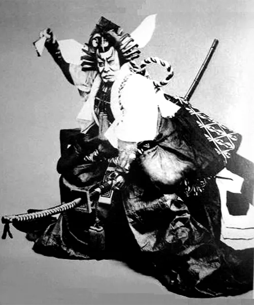 A historic photograph of Kabuki actor Ichikawa Danjuro IX in dramatic costume and pose
